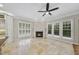 Living area features large windows, travertine flooring, and a fireplace at 12257 Beestone Ln, Raleigh, NC 27614
