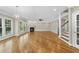 Open living space with hardwood floors, fireplace, and staircase at 12257 Beestone Ln, Raleigh, NC 27614