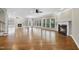 Expansive living room with dual fireplaces, large windows, and hardwood flooring at 12257 Beestone Ln, Raleigh, NC 27614