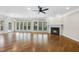 Spacious living room featuring hardwood flooring, a fireplace, and abundant natural light at 12257 Beestone Ln, Raleigh, NC 27614