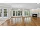 Living room with large windows, natural light and a fireplace at 12257 Beestone Ln, Raleigh, NC 27614