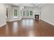 The fireplace is the focal point in this naturally lit living room with wood flooring at 12257 Beestone Ln, Raleigh, NC 27614