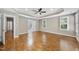 Large main bedroom with hardwood floors, neutral paint, and an open door to the ensuite bath at 12257 Beestone Ln, Raleigh, NC 27614