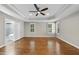 Spacious main bedroom with hardwood floors, a ceiling fan, and bright natural light at 12257 Beestone Ln, Raleigh, NC 27614