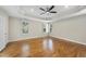 Bright main bedroom features hardwood floors, a ceiling fan, and views of the outdoors at 12257 Beestone Ln, Raleigh, NC 27614