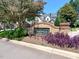 A brick-walled sign with the neighborhood name 'Deauville' surrounded by vibrant plants at 12257 Beestone Ln, Raleigh, NC 27614