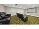 Home theater featuring tiered seating with plush leather recliners and a large projection screen at 12257 Beestone Ln, Raleigh, NC 27614