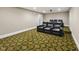 Home theater with tiered seating, plush black recliners, and a large screen for entertainment at 12257 Beestone Ln, Raleigh, NC 27614