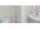 Powder room features pedestal sink and elongated toilet at 132 Pisgah St, Sanford, NC 27330