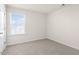 Bright bedroom features plush carpet and view of neighborhood at 132 Pisgah St, Sanford, NC 27330