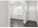 Inviting foyer with wood-look floors, a white front door, and natural light from the window at 132 Pisgah St, Sanford, NC 27330