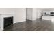 Open-concept living room with a fireplace and wood-look flooring at 132 Pisgah St, Sanford, NC 27330