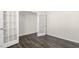 Bright room with wood-look floors and glass paneled french doors at 132 Pisgah St, Sanford, NC 27330