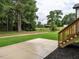 Backyard concrete patio with stairs leading to lawn and trees provides a relaxing outdoor space at 1328 Bethlehem Church Rd, Youngsville, NC 27596