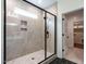 Walk-in shower featuring black hardware, a shower niche, and a glass enclosure at 1328 Bethlehem Church Rd, Youngsville, NC 27596