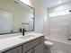 Bathroom with tub/shower combo, white countertop, matte black faucet and hardware and framed mirror at 1328 Bethlehem Church Rd, Youngsville, NC 27596