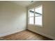 Cozy bedroom with wood-look floors, neutral walls, and a bright window at 1328 Bethlehem Church Rd, Youngsville, NC 27596