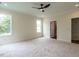 Large bedroom featuring neutral carpeting, ceiling fan, and access to an ensuite bathroom at 1328 Bethlehem Church Rd, Youngsville, NC 27596