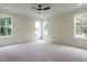 Spacious bedroom with neutral carpet, a modern ceiling fan, and an abundance of natural light at 1328 Bethlehem Church Rd, Youngsville, NC 27596