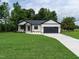 Beautiful one-story home with a black and white color scheme and a long concrete driveway at 1328 Bethlehem Church Rd, Youngsville, NC 27596