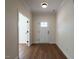 Bright and airy foyer with wood-look flooring and a white front door at 1328 Bethlehem Church Rd, Youngsville, NC 27596