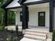 Inviting front porch with classic brick steps and stylish black support columns at 1328 Bethlehem Church Rd, Youngsville, NC 27596
