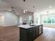 Kitchen island overlooks living room with modern fireplace and ample natural light at 1328 Bethlehem Church Rd, Youngsville, NC 27596