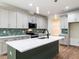 Kitchen features a large island, sleek countertops, modern appliances, and stylish backsplash at 1328 Bethlehem Church Rd, Youngsville, NC 27596