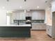 Kitchen features a large island, sleek countertops, modern appliances, and stylish backsplash at 1328 Bethlehem Church Rd, Youngsville, NC 27596
