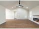 Bright living room boasts high ceilings, modern ceiling fan, wood floors and cozy fireplace at 1328 Bethlehem Church Rd, Youngsville, NC 27596