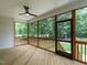 Enclosed porch features wood flooring, ceiling fan, and screens providing views of the outdoor scenery at 1328 Bethlehem Church Rd, Youngsville, NC 27596
