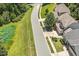 Neighborhood street view with sidewalks, well-manicured lawns, and mature trees at 1413 Lily Creek Dr, Cary, NC 27518