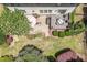 Aerial view of the backyard with patio, deck, firepit, and mature landscaping at 1413 Lily Creek Dr, Cary, NC 27518