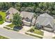 Beautiful aerial of a single Gathering home featuring a three car garage and mature landscaping at 1413 Lily Creek Dr, Cary, NC 27518