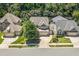 Beautiful aerial of a single Gathering home featuring a three car garage, mature landscaping, and sidewalks at 1413 Lily Creek Dr, Cary, NC 27518