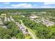 An aerial view of a neighborhood with mature trees, winding roads, and green spaces at 1413 Lily Creek Dr, Cary, NC 27518