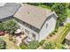 Spacious single Gathering home featuring a wooden deck, stone patio, and mature landscaping at 1413 Lily Creek Dr, Cary, NC 27518