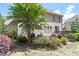 Backyard featuring a deck, patio, lush landscaping, and various seating arrangements at 1413 Lily Creek Dr, Cary, NC 27518