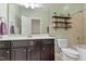 Bathroom with a single sink vanity, toilet, and shelves at 1413 Lily Creek Dr, Cary, NC 27518