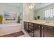 Bathroom with double vanity, garden tub, decorative mirror, and natural lighting at 1413 Lily Creek Dr, Cary, NC 27518