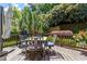 Relax on this wood deck with a grill, comfortable seating, and mature landscaping to ensure privacy at 1413 Lily Creek Dr, Cary, NC 27518
