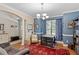 Cozy dining room with blue walls, dark wood table, and natural light from window at 1413 Lily Creek Dr, Cary, NC 27518