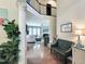 Open foyer with hardwood floors and a view of the living room, showcasing natural light and space at 1413 Lily Creek Dr, Cary, NC 27518