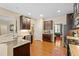 Open concept kitchen boasts stainless steel appliances, granite counters, and hardwood floors at 1413 Lily Creek Dr, Cary, NC 27518