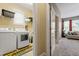 Laundry room with washer, dryer, and adjacent carpeted room at 1413 Lily Creek Dr, Cary, NC 27518