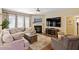 Comfortable living room with a fireplace, large windows, and modern furniture at 1413 Lily Creek Dr, Cary, NC 27518