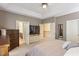 Spacious main bedroom featuring neutral tones, tray ceiling, and ensuite bathroom access at 1413 Lily Creek Dr, Cary, NC 27518