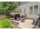 Relaxing patio area featuring a fire pit, comfortable seating, and shade umbrella at 1413 Lily Creek Dr, Cary, NC 27518