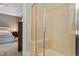 Tiled shower with a built-in bench and glass enclosure, conveniently located next to the main bedroom at 1413 Lily Creek Dr, Cary, NC 27518