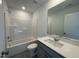 This bathroom is modern with a shower and a vanity sink with a large mirror at 154 N Finley Landing Pkwy, Smithfield, NC 27577